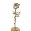 a gold rose with a name on it